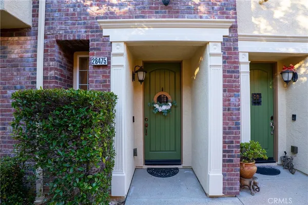 an entrance to house with potted plants