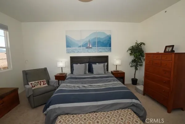 a bedroom with a bed and with furniture