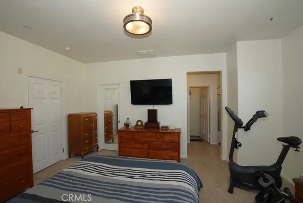 a bedroom with furniture and a flat screen tv