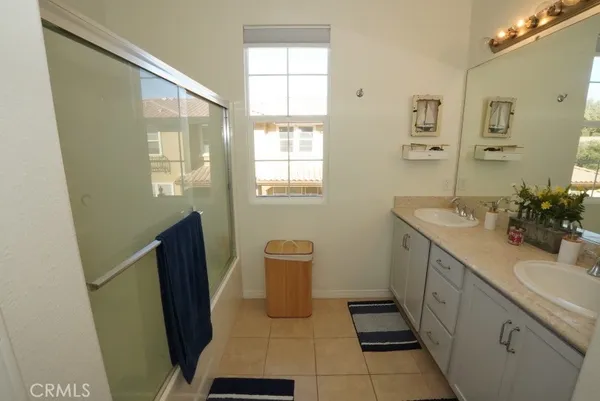 a bathroom with sink shower and a mirror
