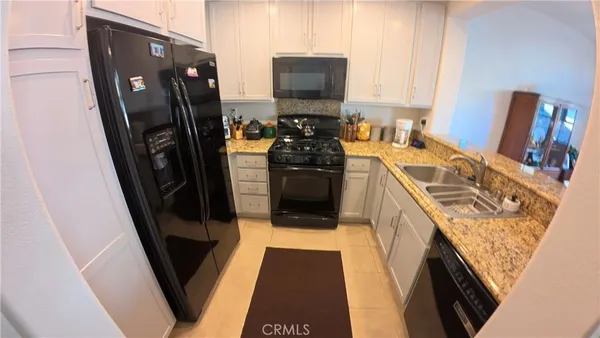 a kitchen with a sink a refrigerator and washer