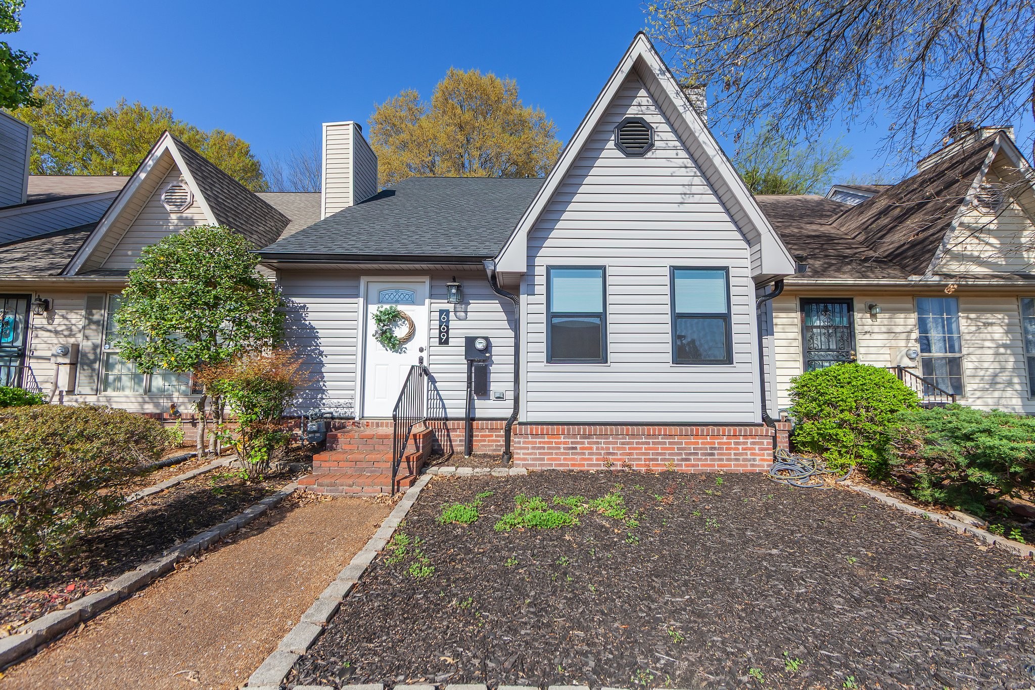 a front view of a house with garden