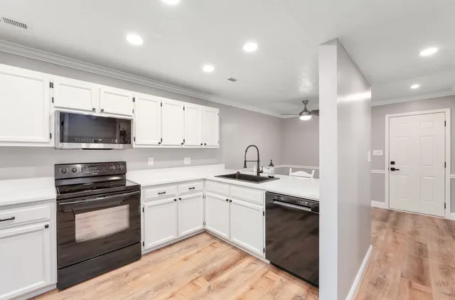 a kitchen with a sink stove and microwave