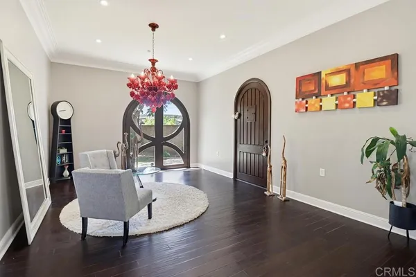 a dining room with furniture potted plants and wooden floor