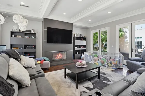 a living room with furniture a fireplace and a flat screen tv