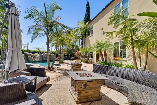 a view of a patio with couches and a fire pit