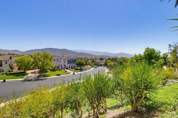 a view of residential houses with outdoor space and street view