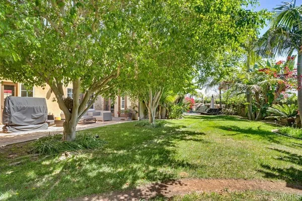 a backyard of a house with a yard and outdoor seating