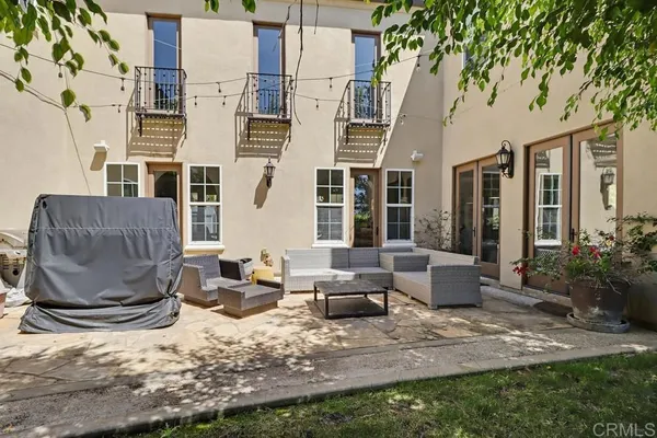 a view of backyard with outdoor seating ad green space