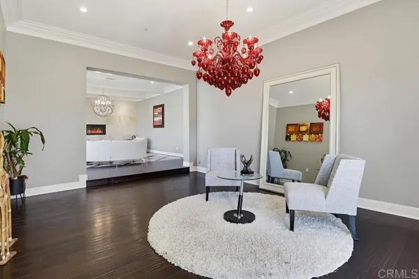 a living room with furniture and a chandelier