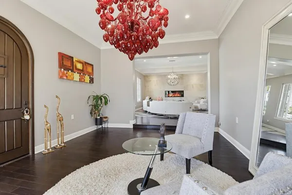 a living room with furniture and a chandelier