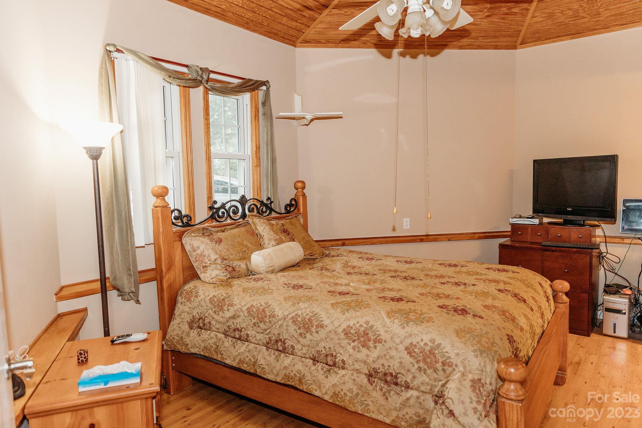 8808 Webb Road Stanfield, NC 28163 - Photo 12 of 33 a bedroom with a bed and flat screen tv