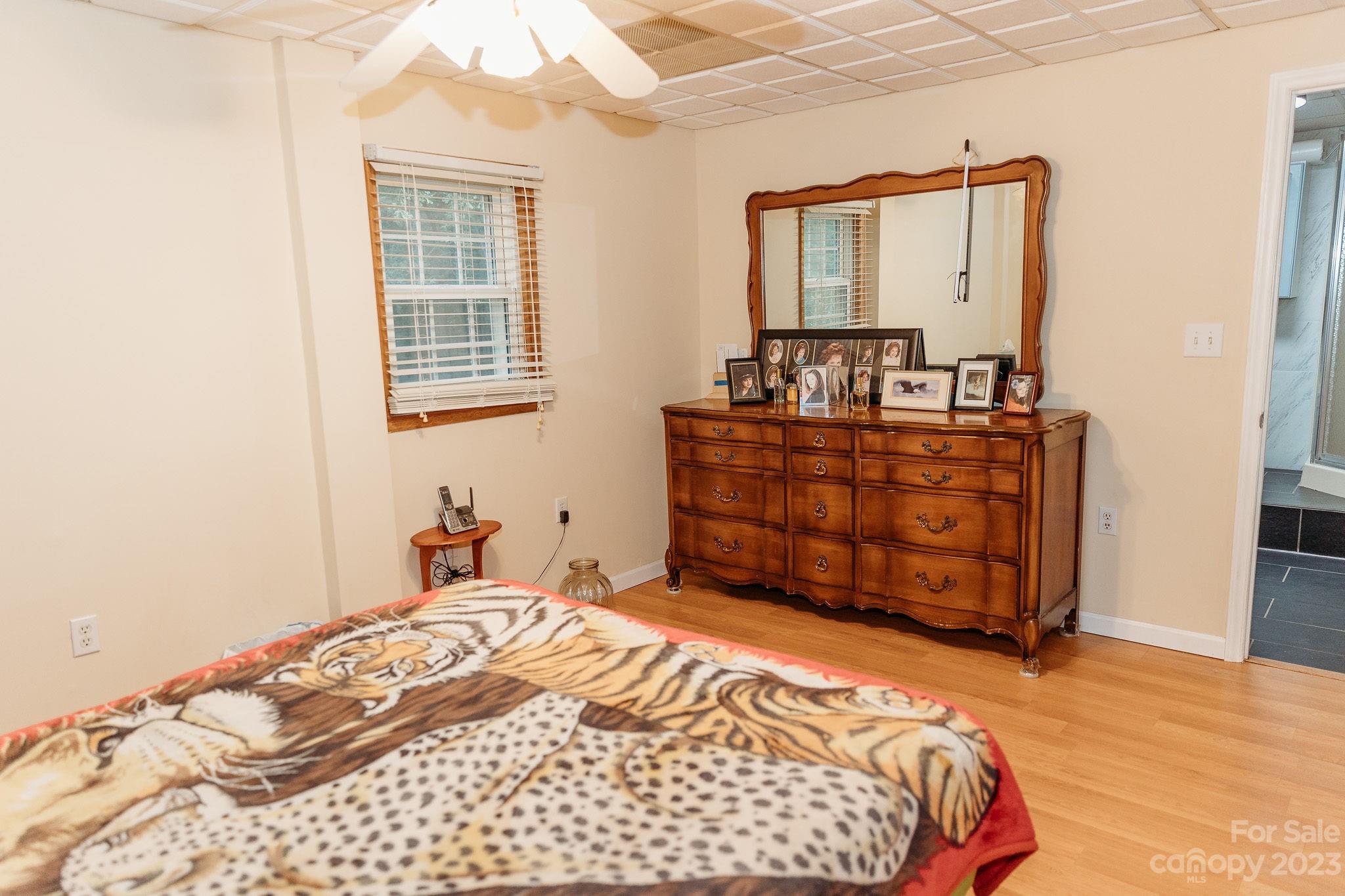 8808 Webb Road Stanfield, NC 28163 - Photo 14 of 33 a bedroom with a bed and a mirror on dresser