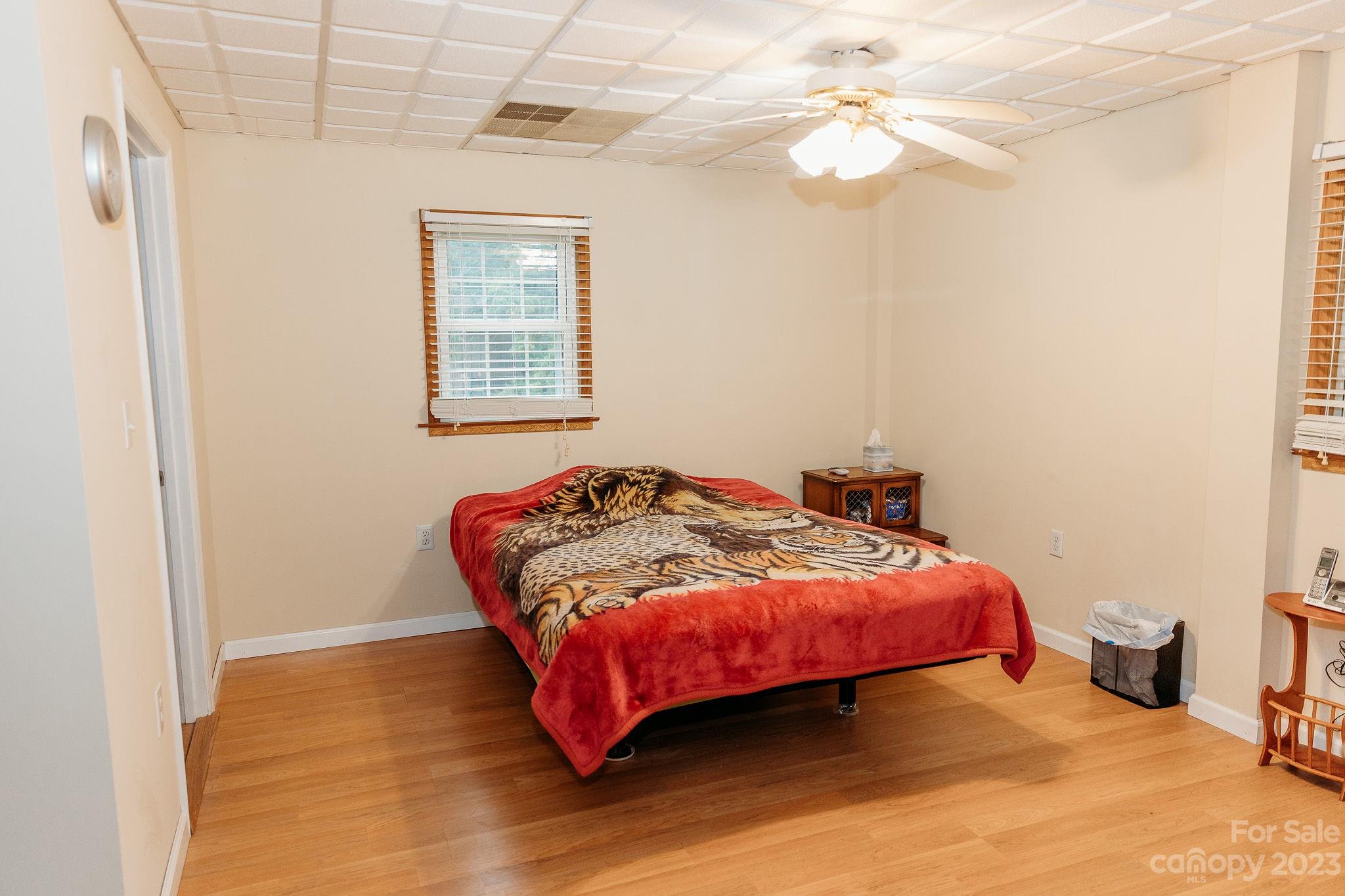 8808 Webb Road Stanfield, NC 28163 - Photo 15 of 33 a bedroom with a bed and a chandelier