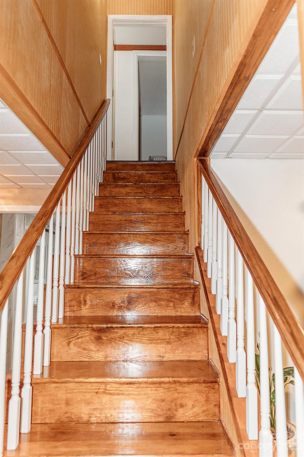 8808 Webb Road Stanfield, NC 28163 - Photo 16 of 33 a view of staircase with wooden floor and white walls