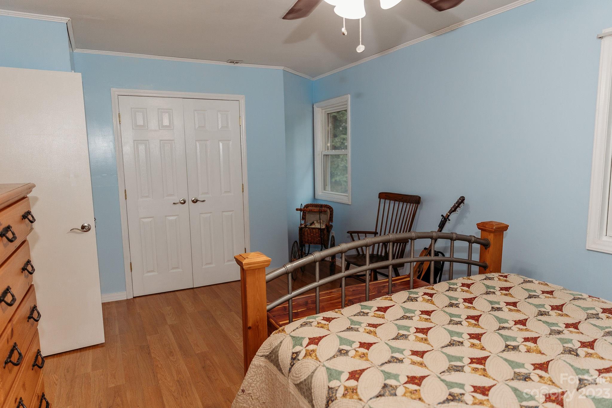 8808 Webb Road Stanfield, NC 28163 - Photo 22 of 33 a bedroom with a bed and a chandelier
