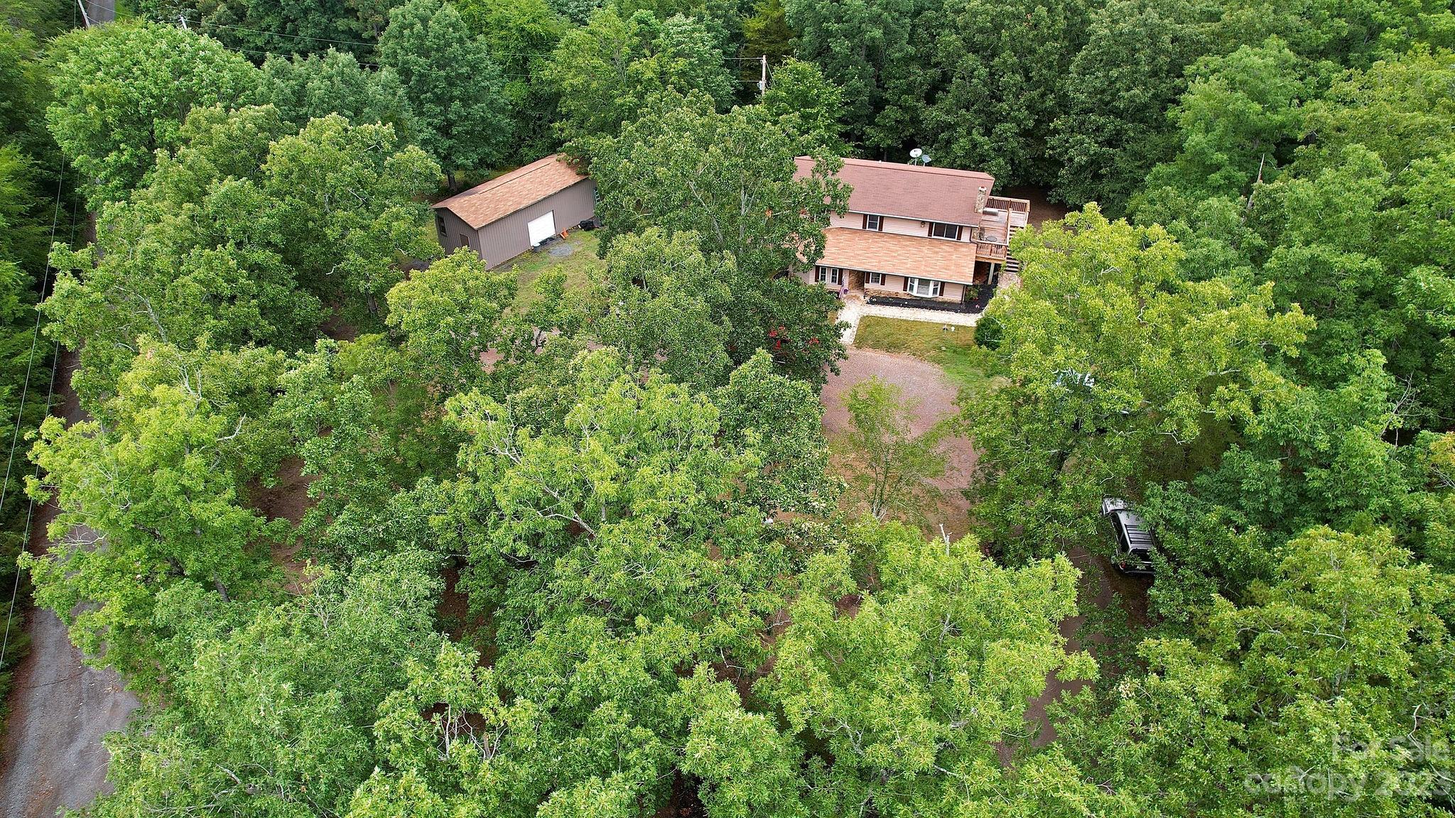 8808 Webb Road Stanfield, NC 28163 - Photo 28 of 33 an aerial view of a house with a yard and trees all around