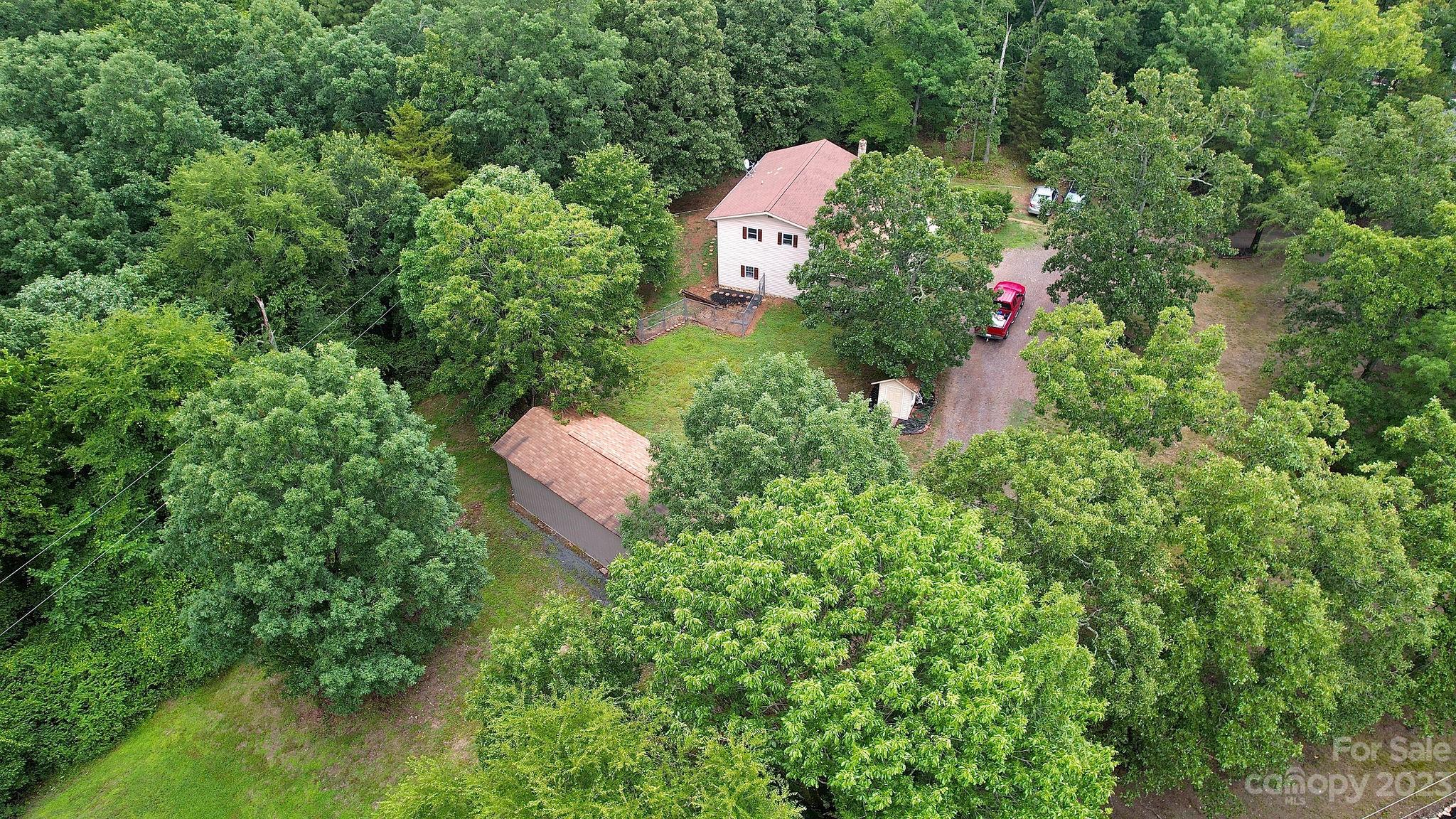 8808 Webb Road Stanfield, NC 28163 - Photo 29 of 33 an aerial view of a house with a yard and greenery