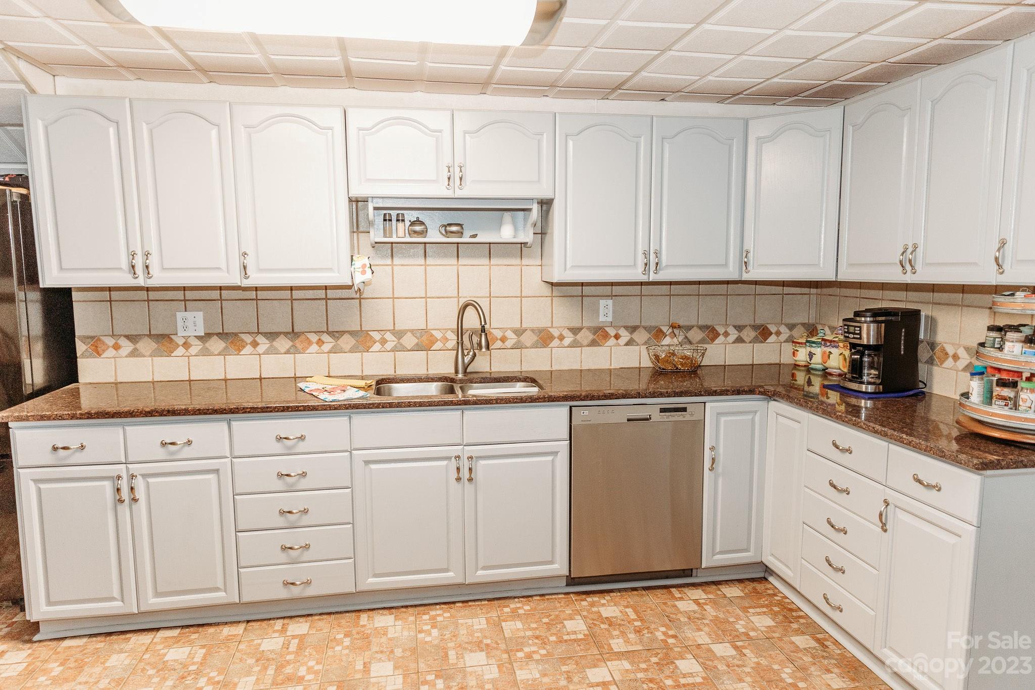 8808 Webb Road Stanfield, NC 28163 - Photo 7 of 33 a kitchen with granite countertop white cabinets stainless steel appliances a sink and a window