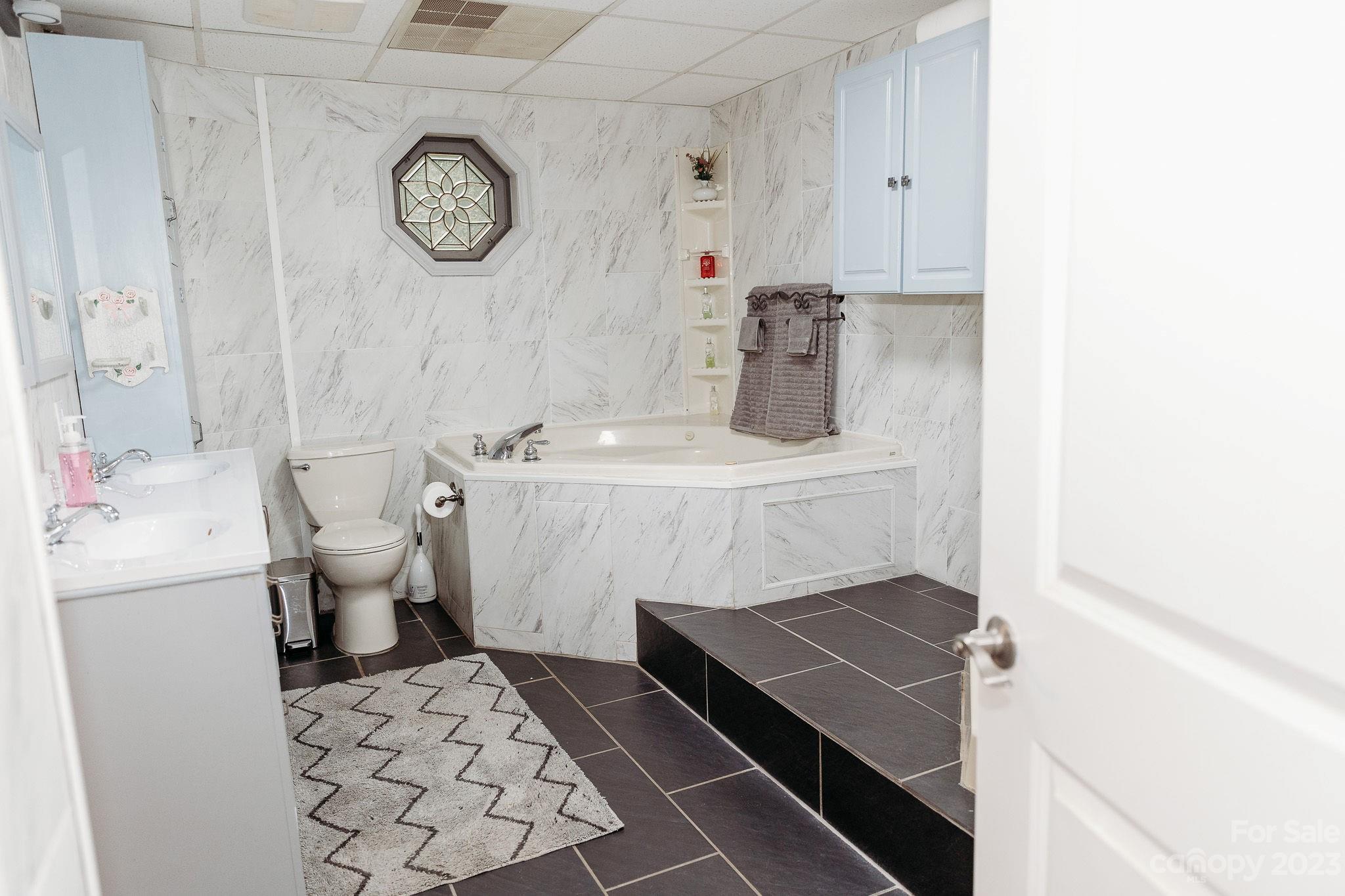 8808 Webb Road Stanfield, NC 28163 - Photo 9 of 33 a bathroom with a sink a toilet and a mirror