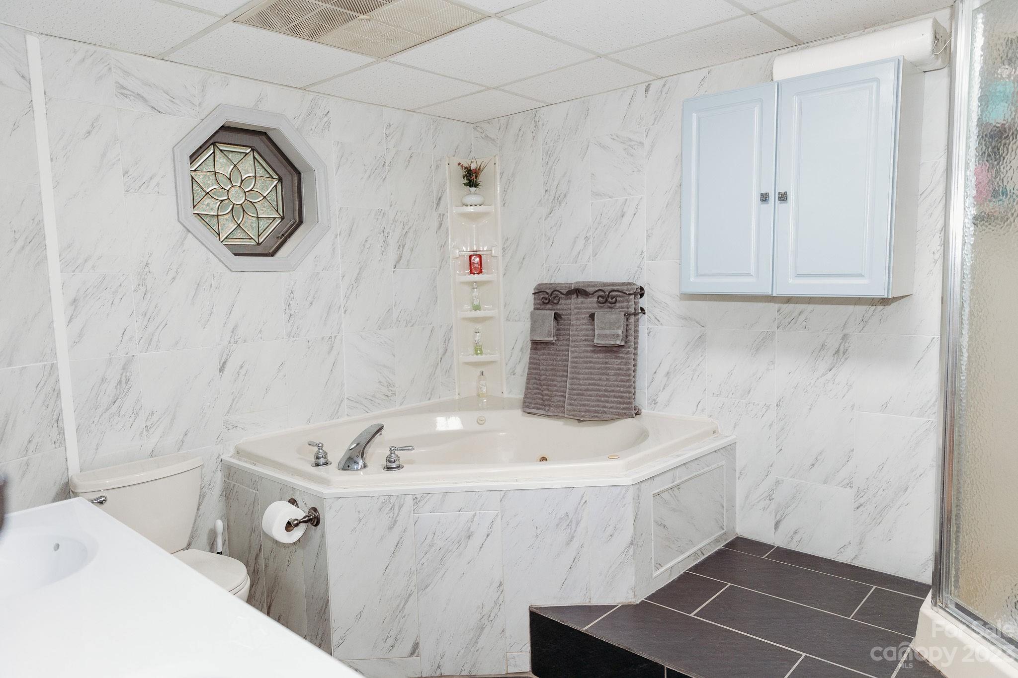 8808 Webb Road Stanfield, NC 28163 - Photo 10 of 33 a bathroom with a bathtub and a sink