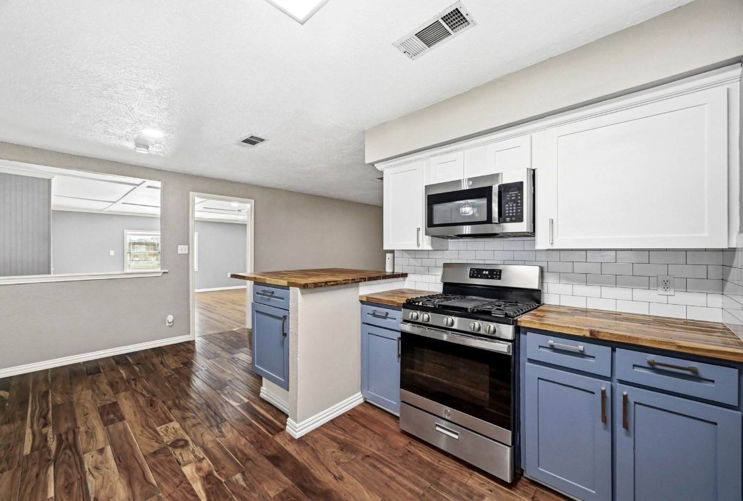3602 Sweet Gum Spring, TX 77388 - Photo 11 of 30 a kitchen with granite countertop a stove top oven and cabinets
