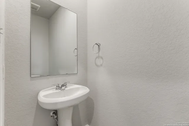 a bathroom with a sink a mirror and vanity
