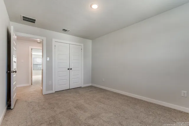 an empty room with closet area