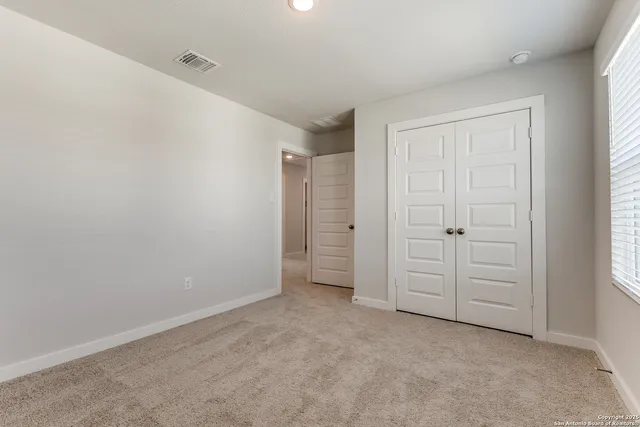 an empty room with closet area