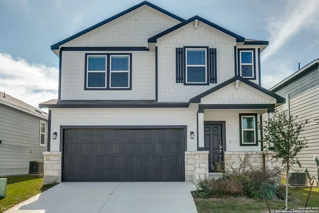 a front view of a house with garage