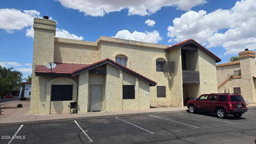 2650 East McKellips Road, Unit 241 Mesa, AZ 85213 - Photo 1 of 2 a car parked in front of a house