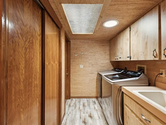 a spacious bathroom with a granite countertop sink a mirror and a shower