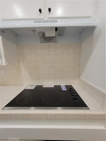 a stove top oven sitting inside of a kitchen