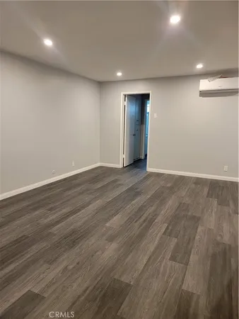 a bathroom with a granite countertop sink mirror and toilet