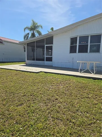 a view of a house with a swimming pool and sitting area