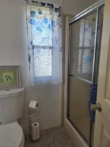 a bedroom with bed and wooden floor