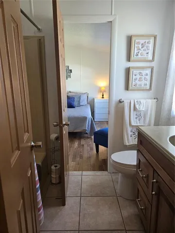 a living room with couches and a dining table with large window