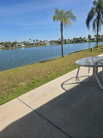 a room with kitchen island a rug a stove and a view of kitchen