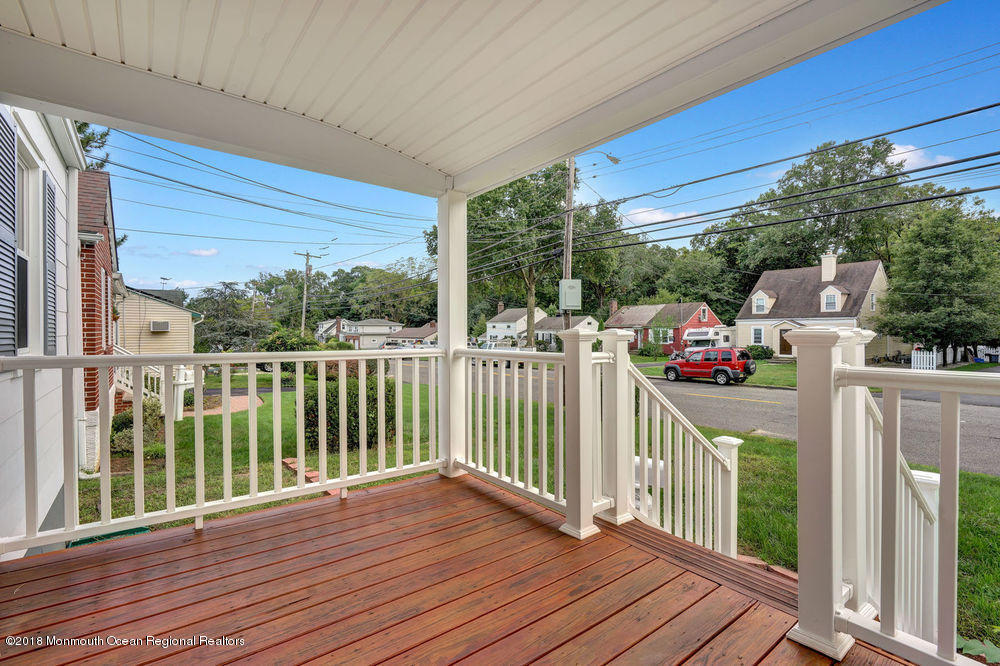 71 Ravine Drive Matawan, NJ 07747 - Photo 4 of 22 a view of a deck with wooden floor and fence