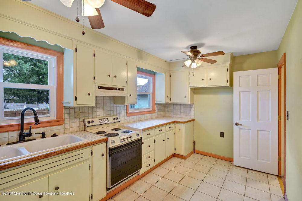 71 Ravine Drive Matawan, NJ 07747 - Photo 8 of 22 a kitchen with a sink cabinets and window