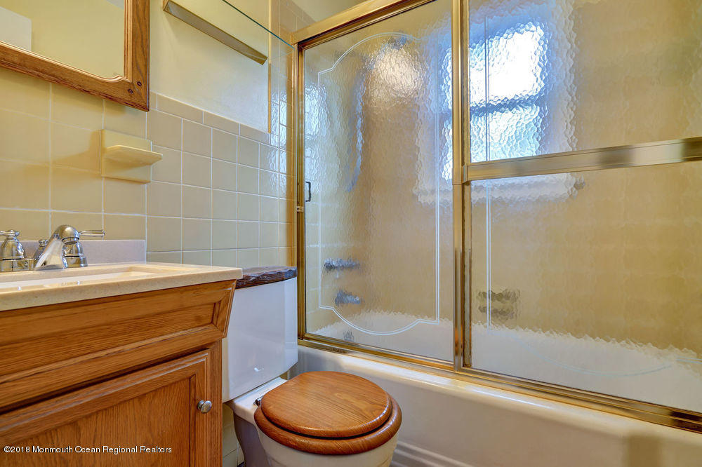 71 Ravine Drive Matawan, NJ 07747 - Photo 10 of 22 a bathroom with a sink a toilet and shower