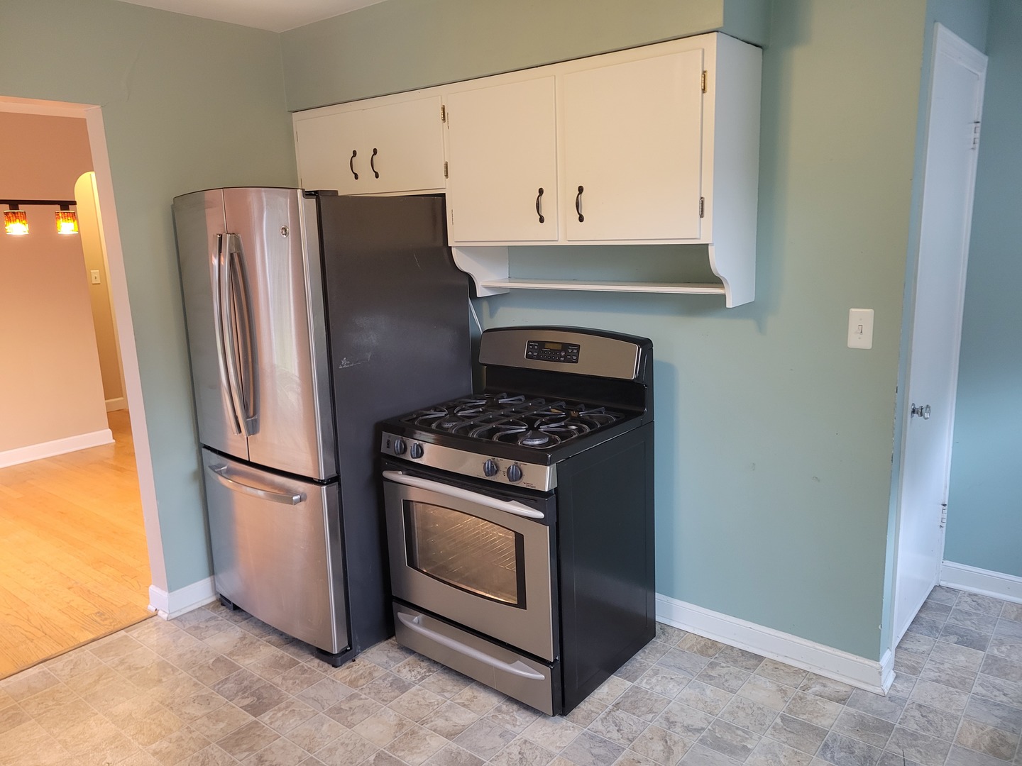8918 Parkside Avenue Morton Grove, IL 60053 - Photo 14 of 36 a kitchen with stainless steel appliances granite countertop a refrigerator a stove and a refrigerator with white cabinets