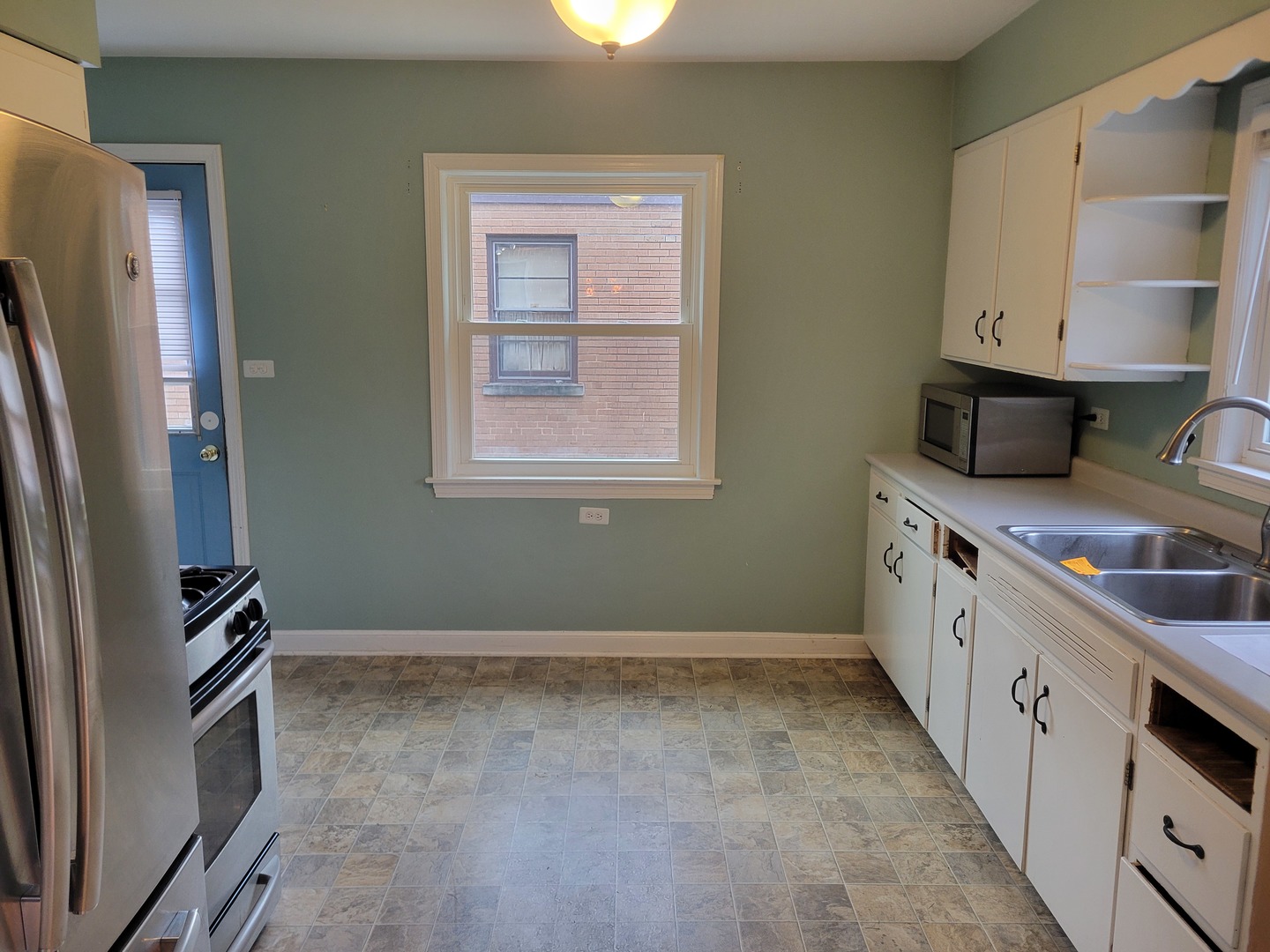 8918 Parkside Avenue Morton Grove, IL 60053 - Photo 15 of 36 a kitchen with stainless steel appliances a sink stove and refrigerator