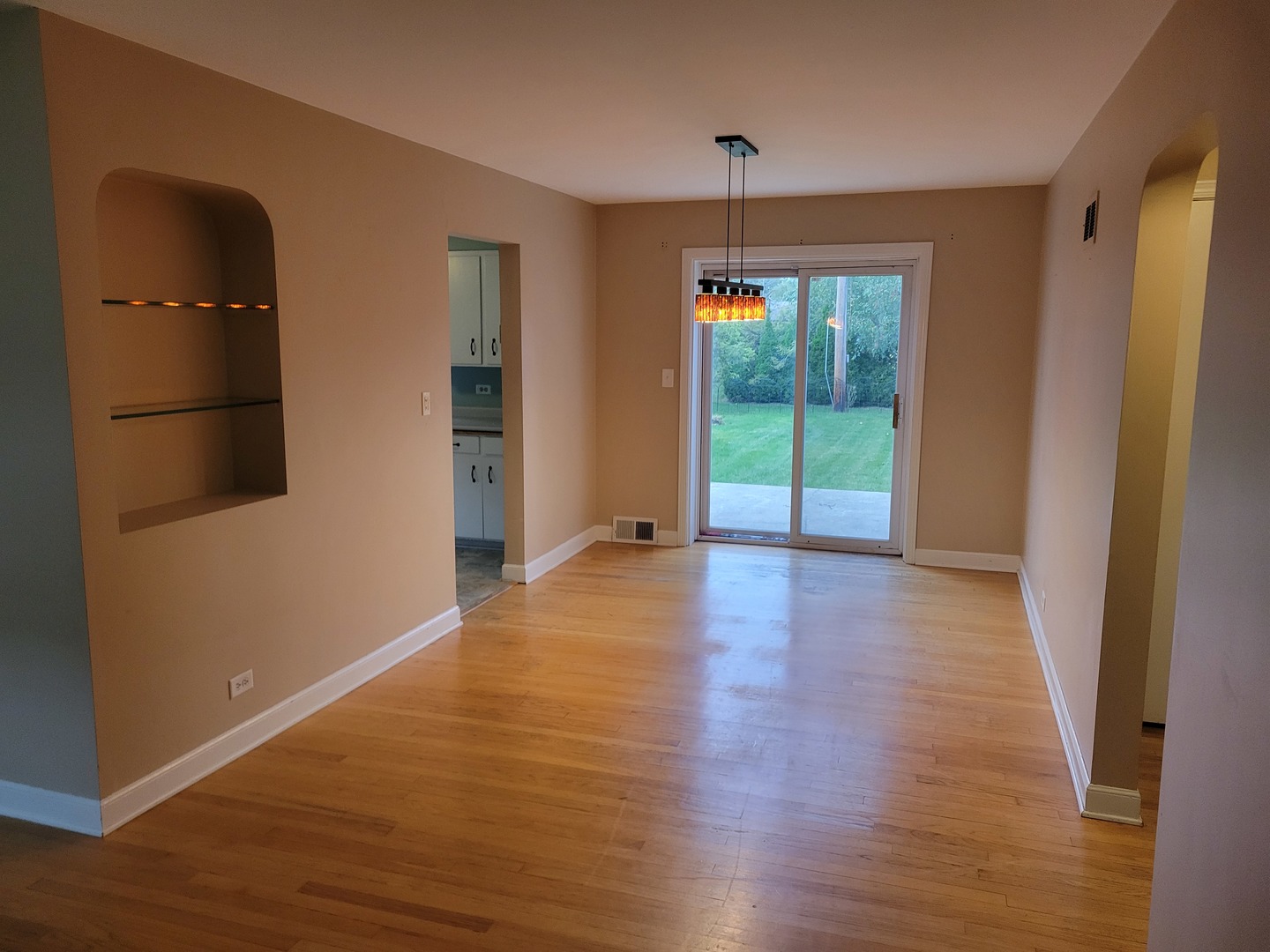 8918 Parkside Avenue Morton Grove, IL 60053 - Photo 17 of 36 an empty room with wooden floor and sliding door