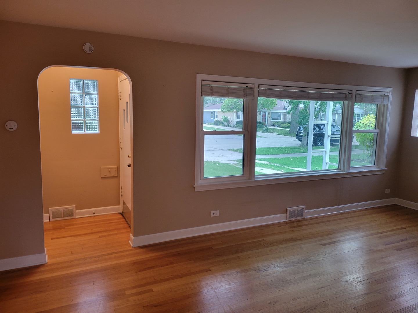 8918 Parkside Avenue Morton Grove, IL 60053 - Photo 21 of 36 a view of an empty room with wooden floor and a window