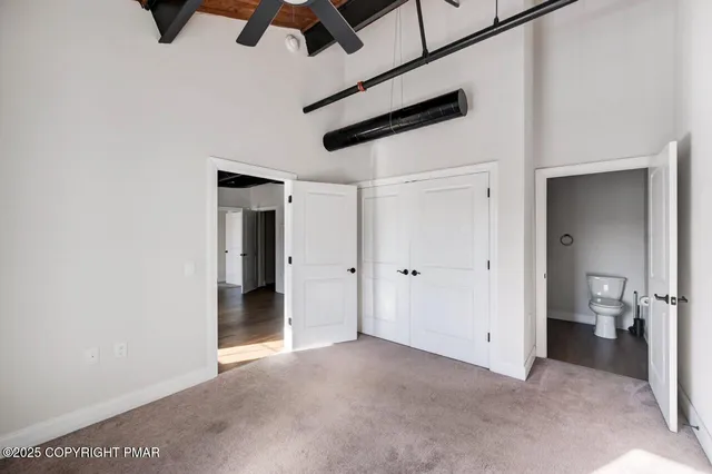 a view of a room with a ceiling fan