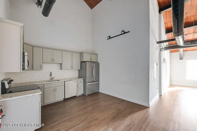 a view of a kitchen with electric appliances