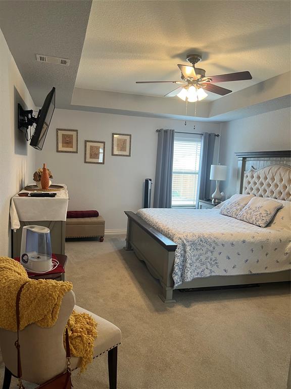 312 McAfee Street Mabank, TX 75147 - Photo 14 of 40 a bedroom with a bed and ceiling fan