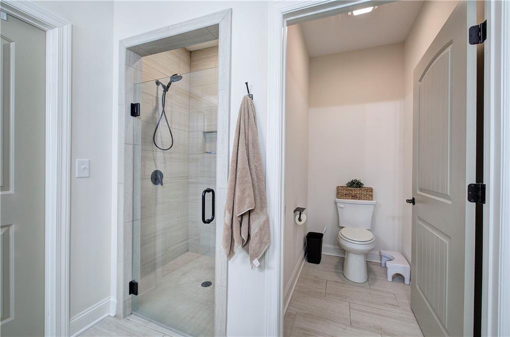 6 Encore Lane Cartersville, GA 30120 - Photo 17 of 33 a bathroom with a granite countertop shower and a toilet