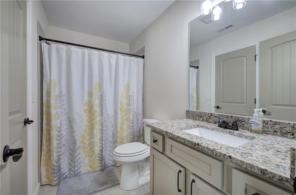 6 Encore Lane Cartersville, GA 30120 - Photo 28 of 33 a bathroom with a granite countertop sink and a mirror
